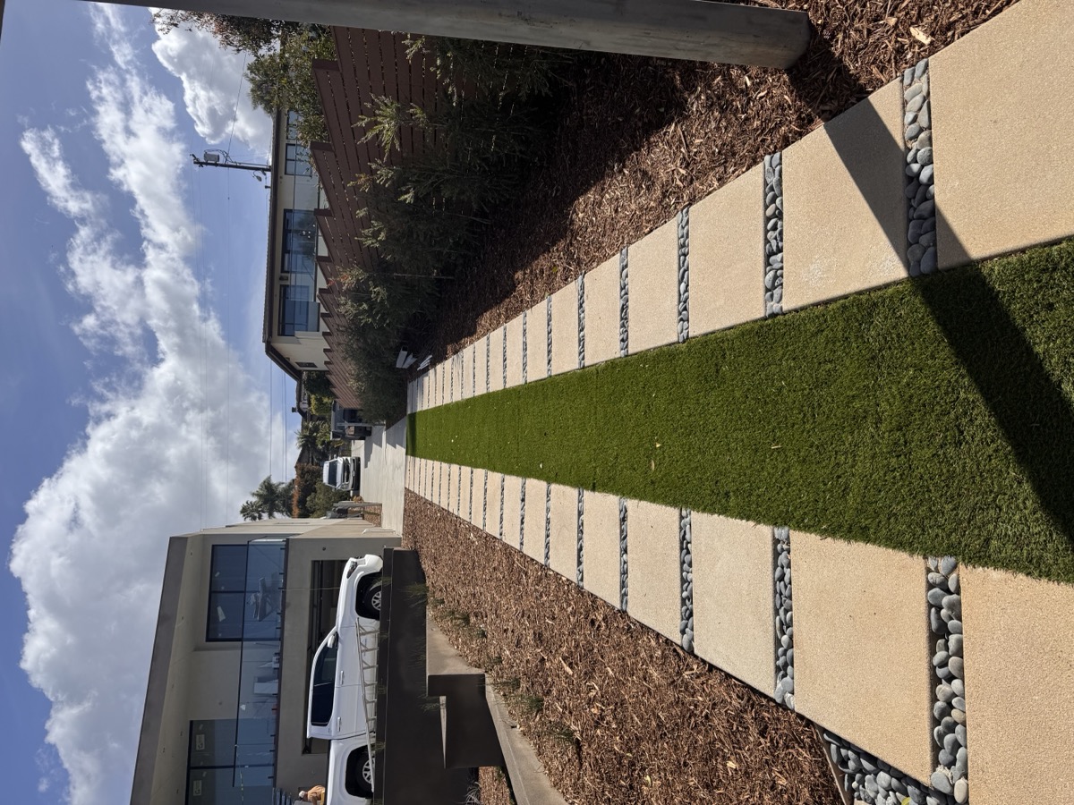 Completed modern landscaping with pavers and turf