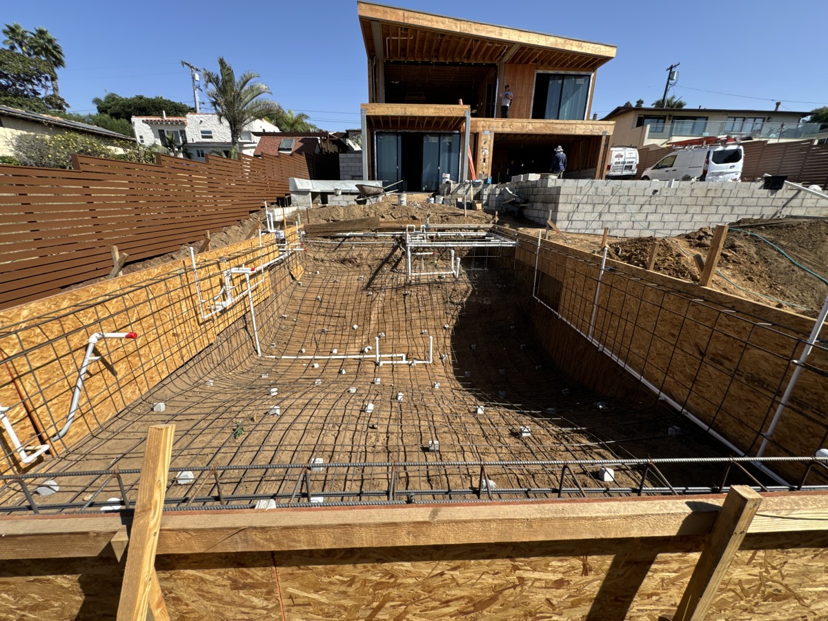 Pool construction with rebar and modern home addition